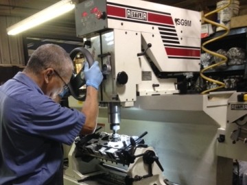 man with glasses fixing cylinder heads