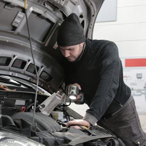 mechanic man checking engine