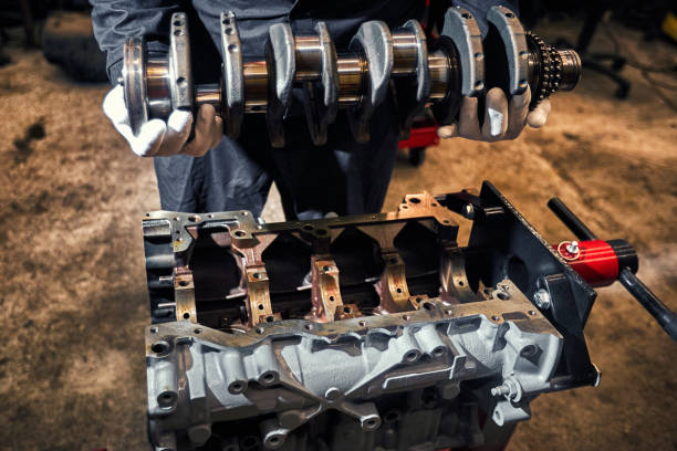 mechanic man holding a crankshaft